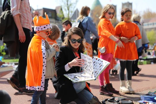 Drukke vrijmarkt en muziekplein in Noord-Holland tijdens programma koningsdag 2026